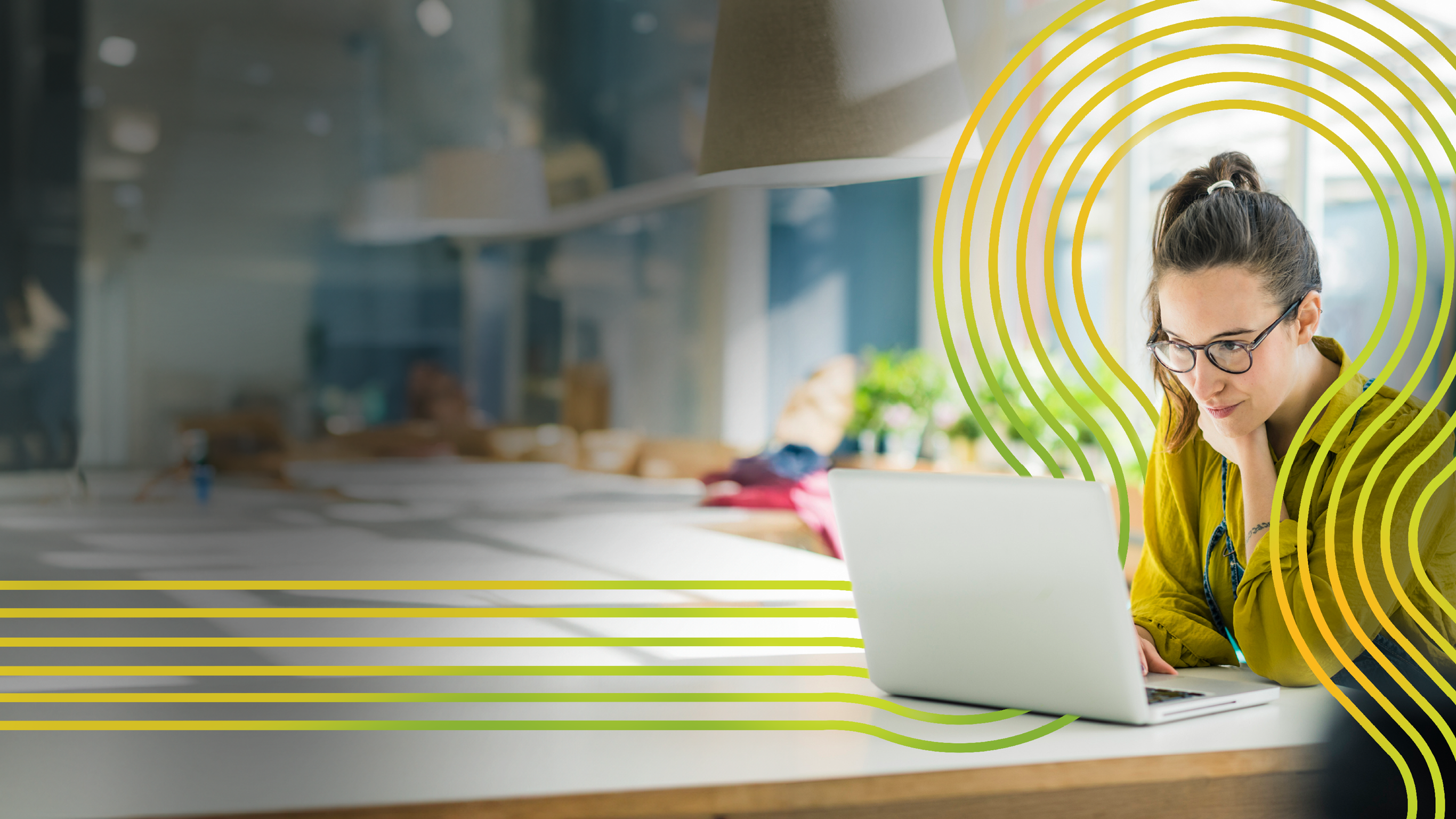 Shot of two young coworkers using a laptop during a late night at work