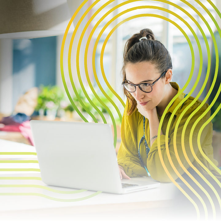 Shot of two young coworkers using a laptop during a late night at work