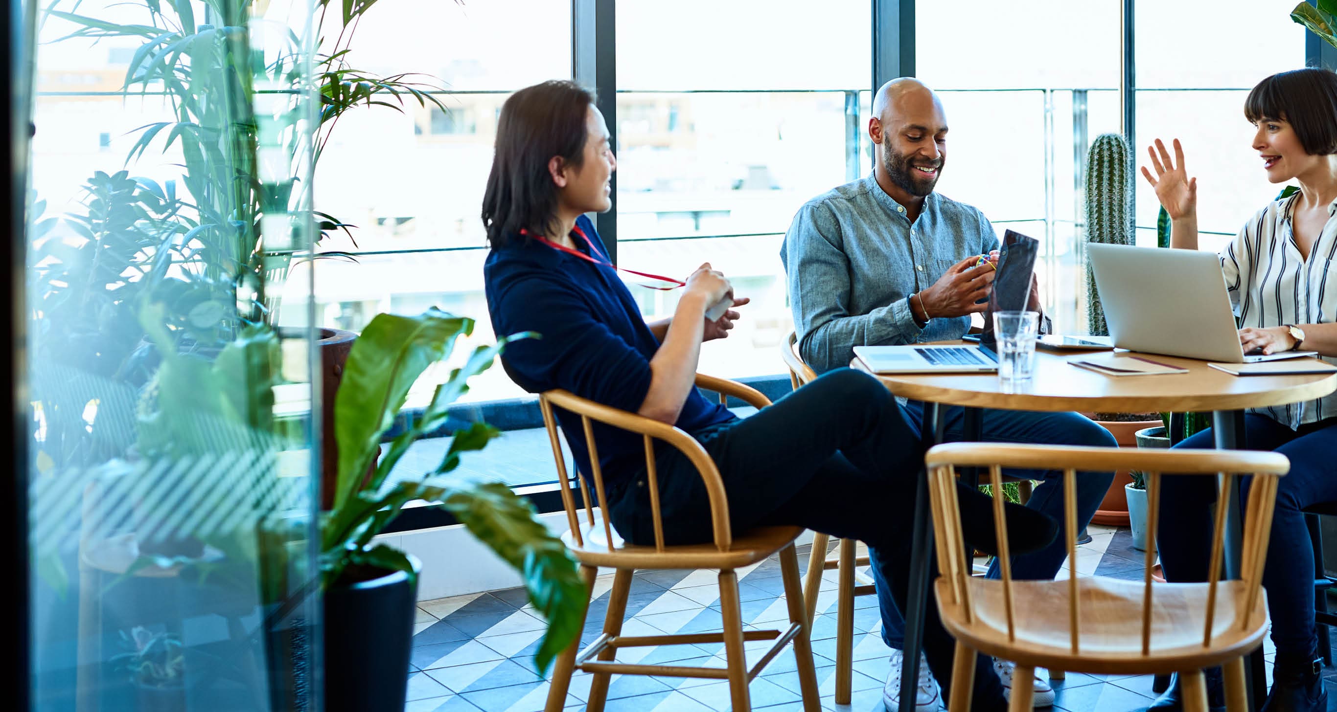 Hispanic businesswoman sitting around table with male colleagues, confidence, leadership, friendship